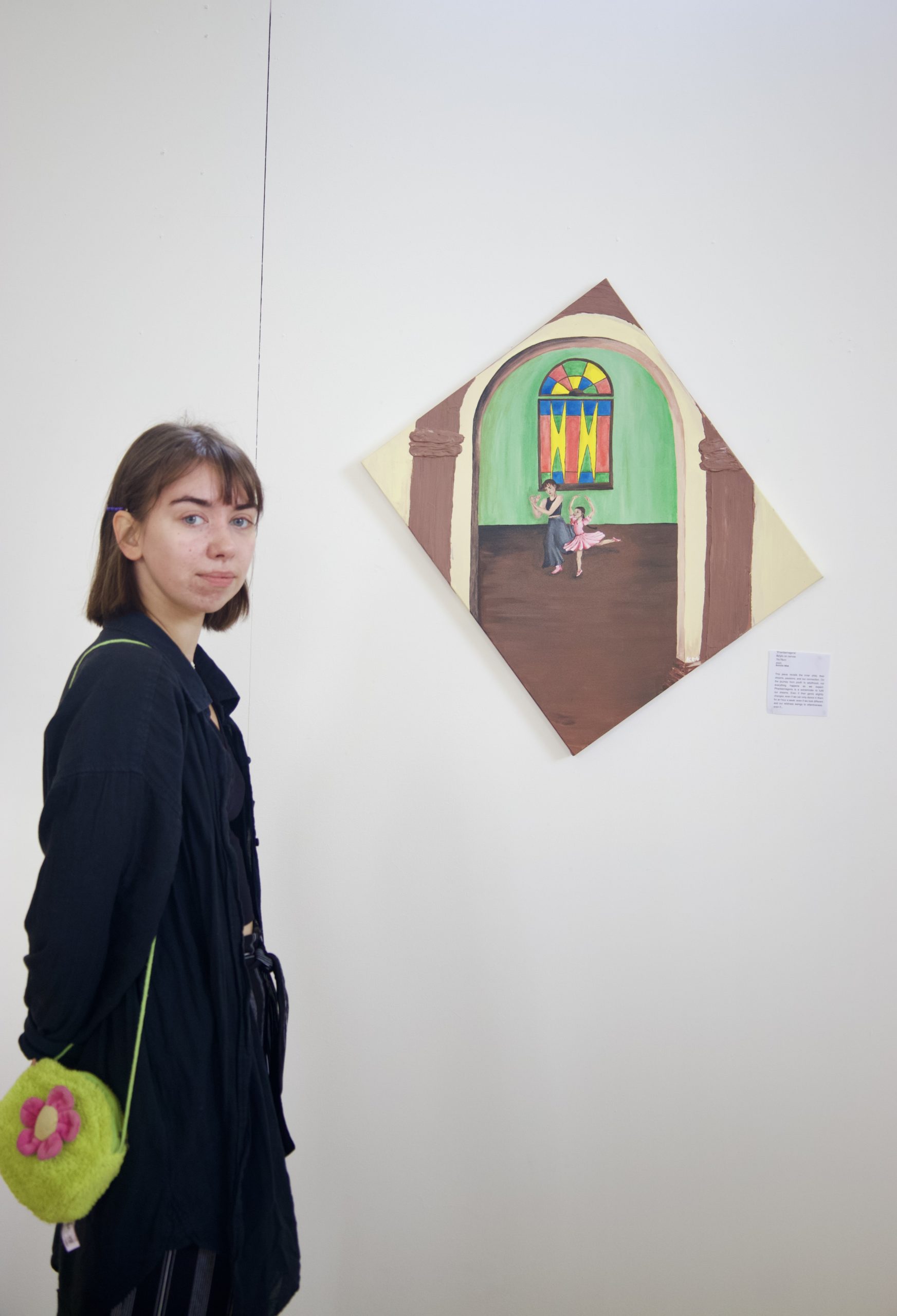 Kornelia Mlak ArchiveOfOurYouth artist standing with their art