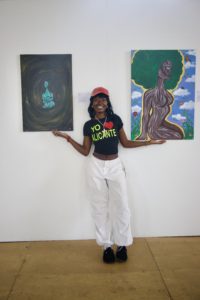 Rabbit ArchiveOfOurYouth artist standing with their art