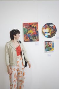 Asia Ciolkosz ArchiveOfOurYouth artist standing with their art